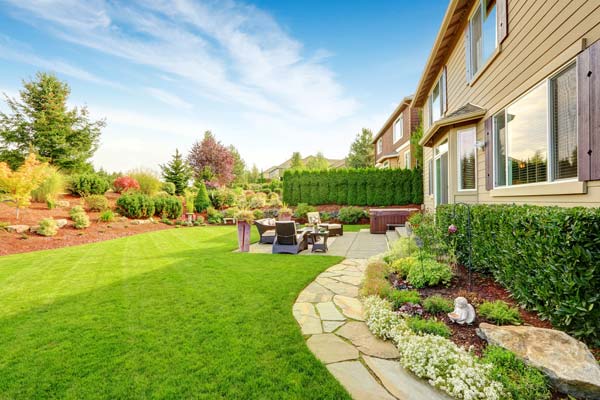 backyard with green grass, and patio chairs